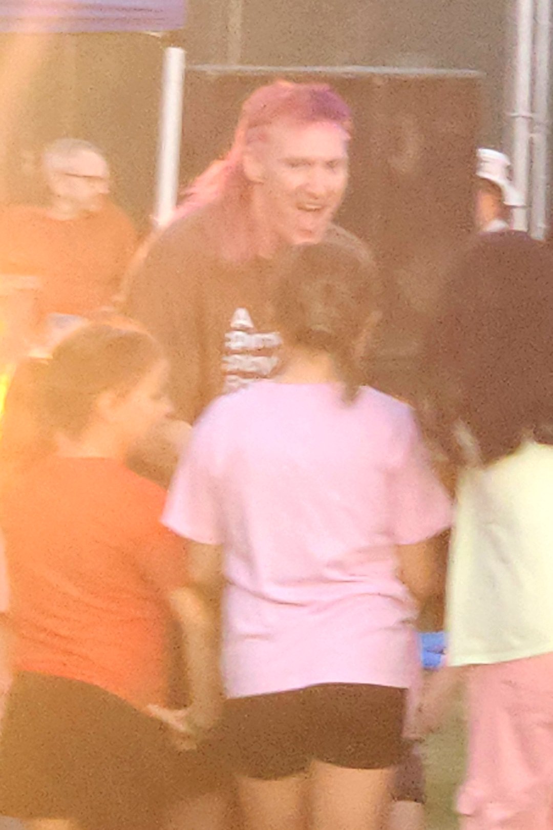 Jared Hippler laughing while leading a group in play at a community event