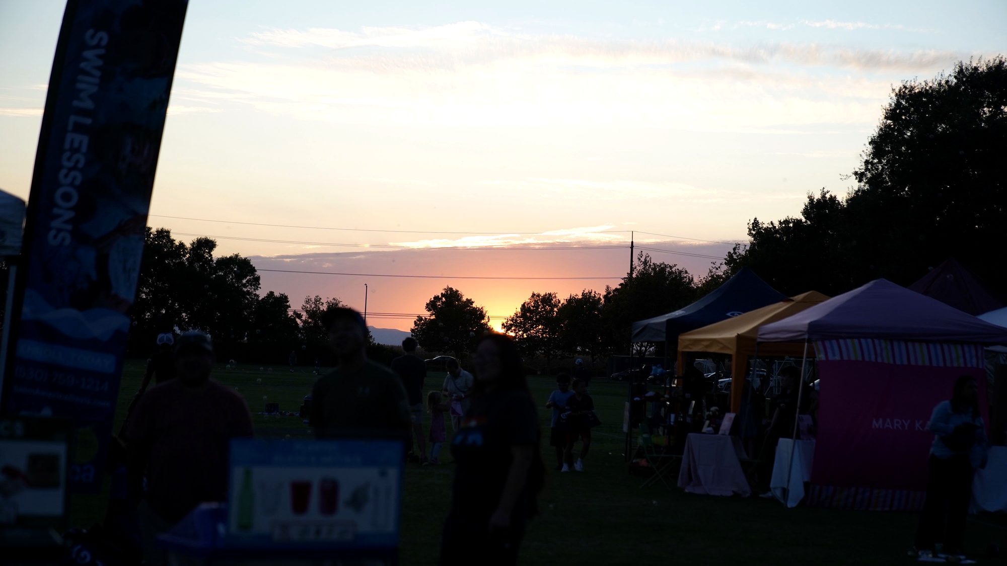 A warm sunset over a community gathering